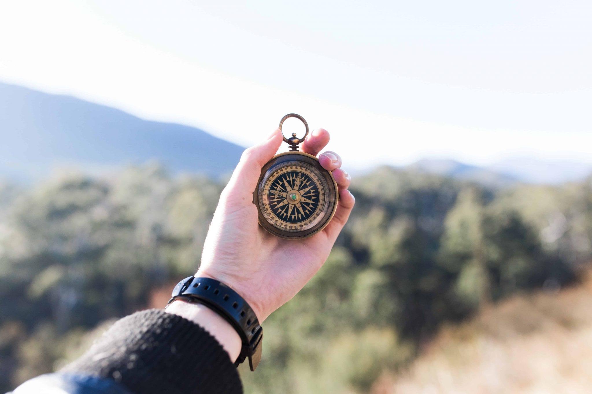 hand holding compass