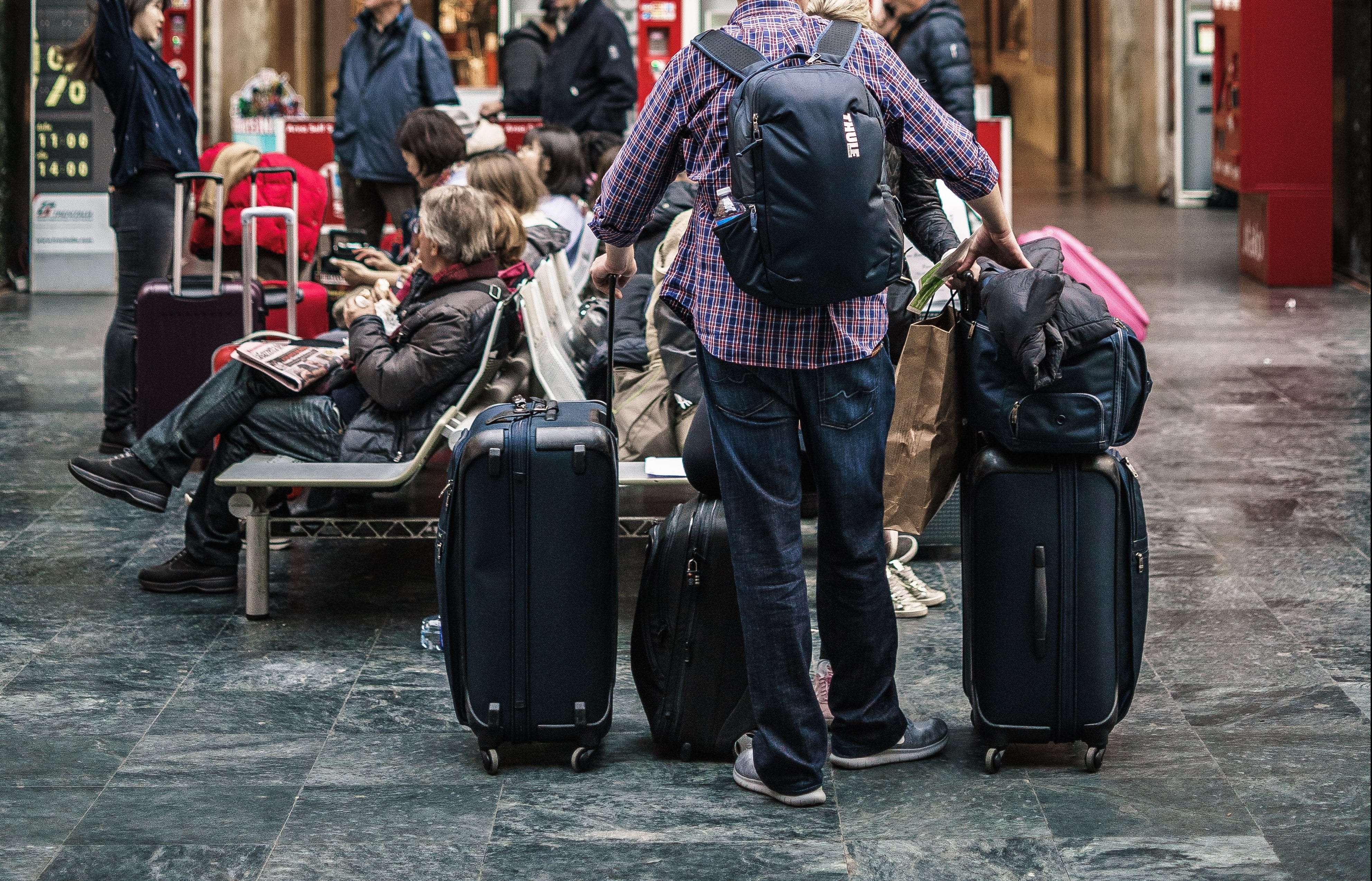 man-holding-luggage-at-airport